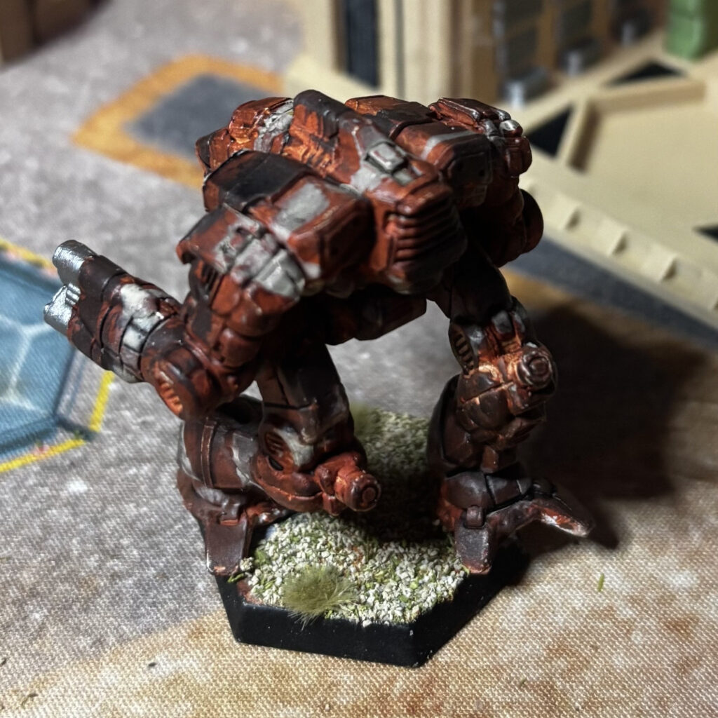 Supernova miniature in red-brown, black, and grey camouflage