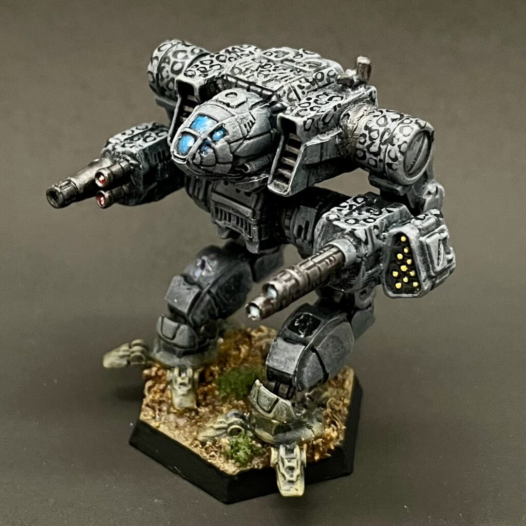 a kitbashed Iron Cheetah miniature painted in grey with white spots ringed in black