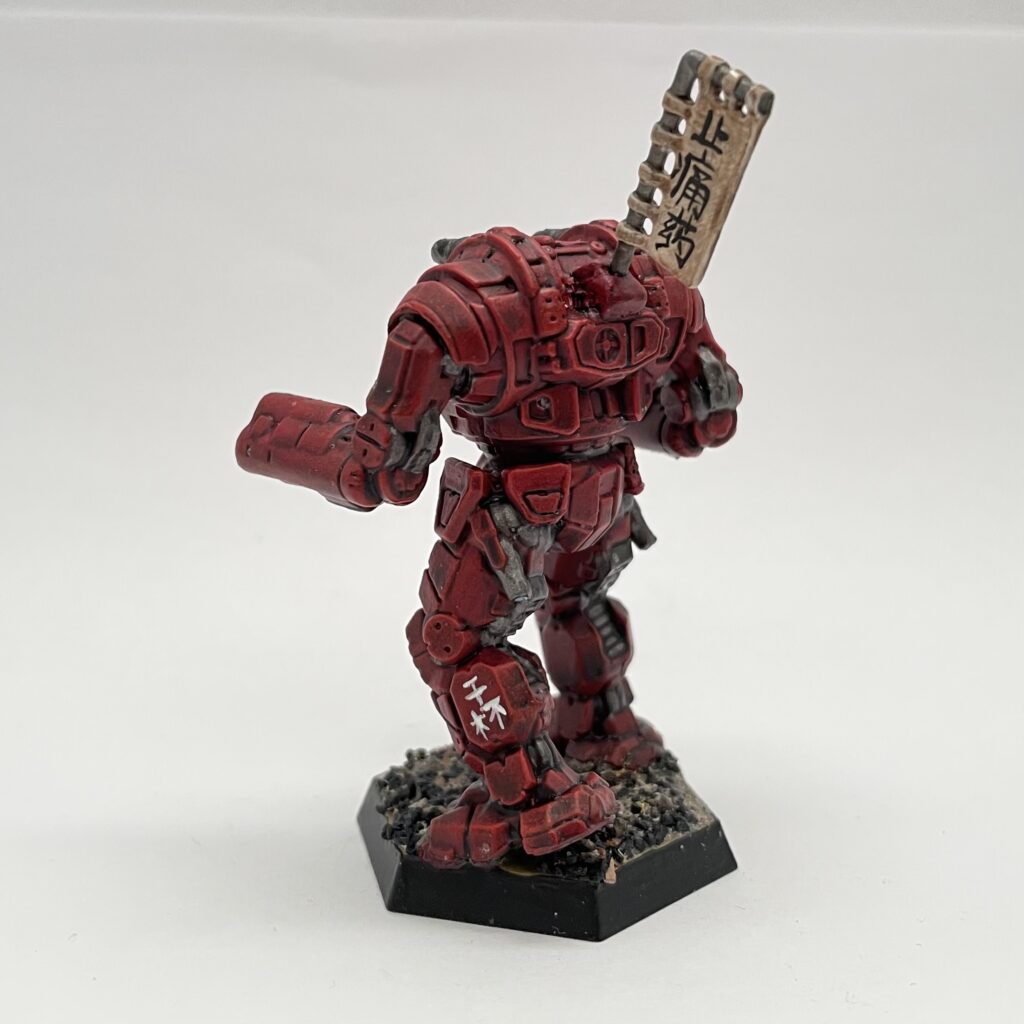 a Gunslinger miniature painted in red with gold accents and a kitbashed banner