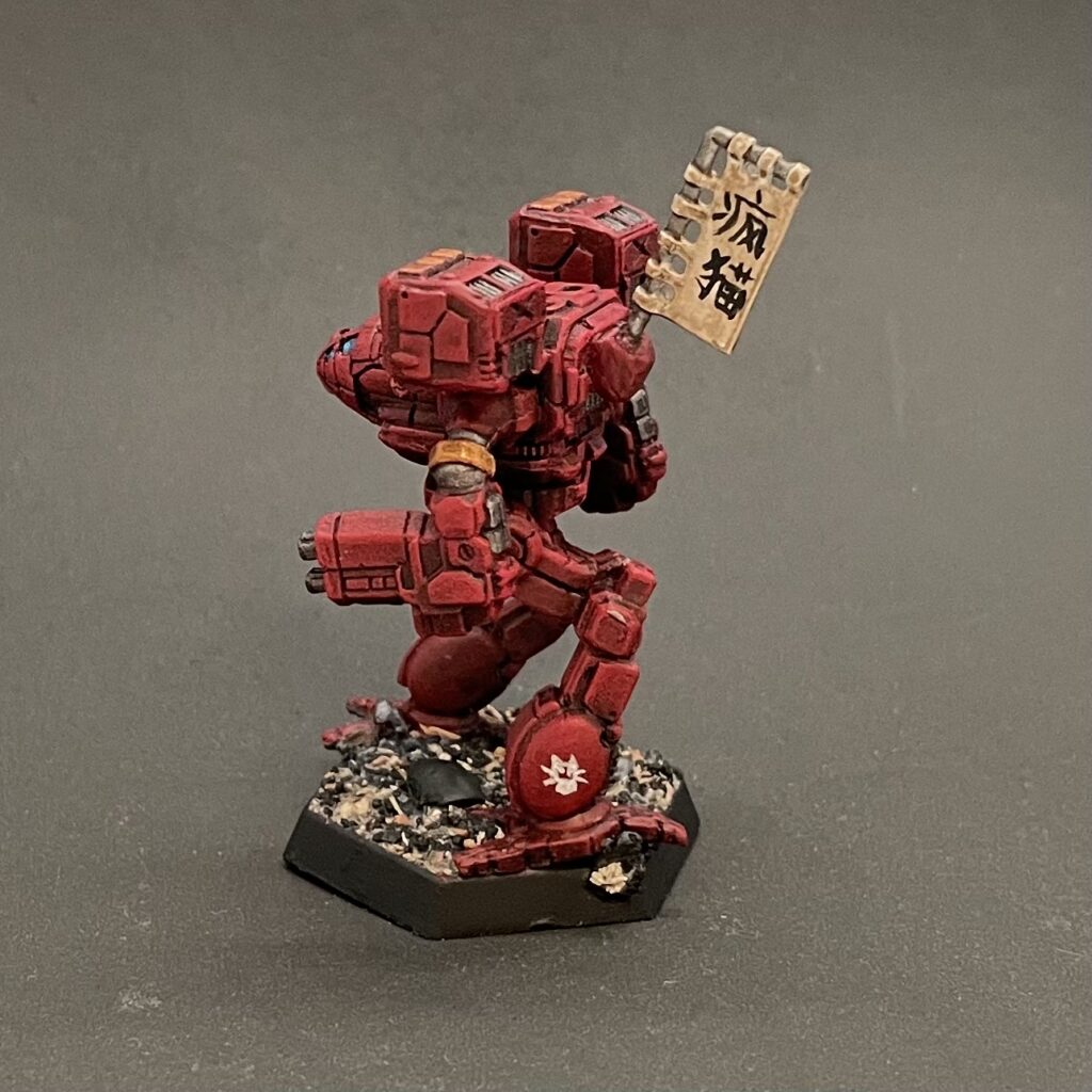 a Timber Wolf miniature painted in red with gold accents and a kitbashed banner