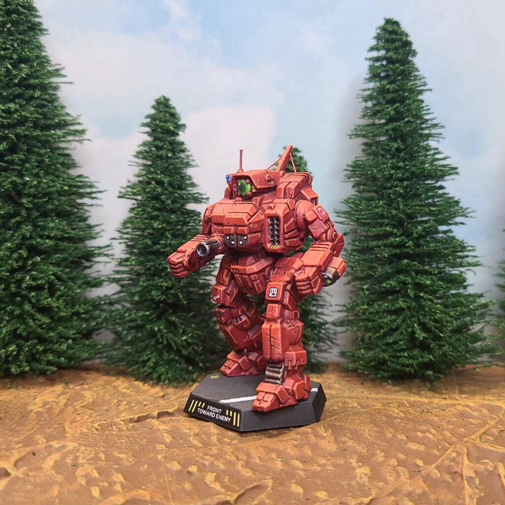 a Cyclops miniature painted red with a green cockpit