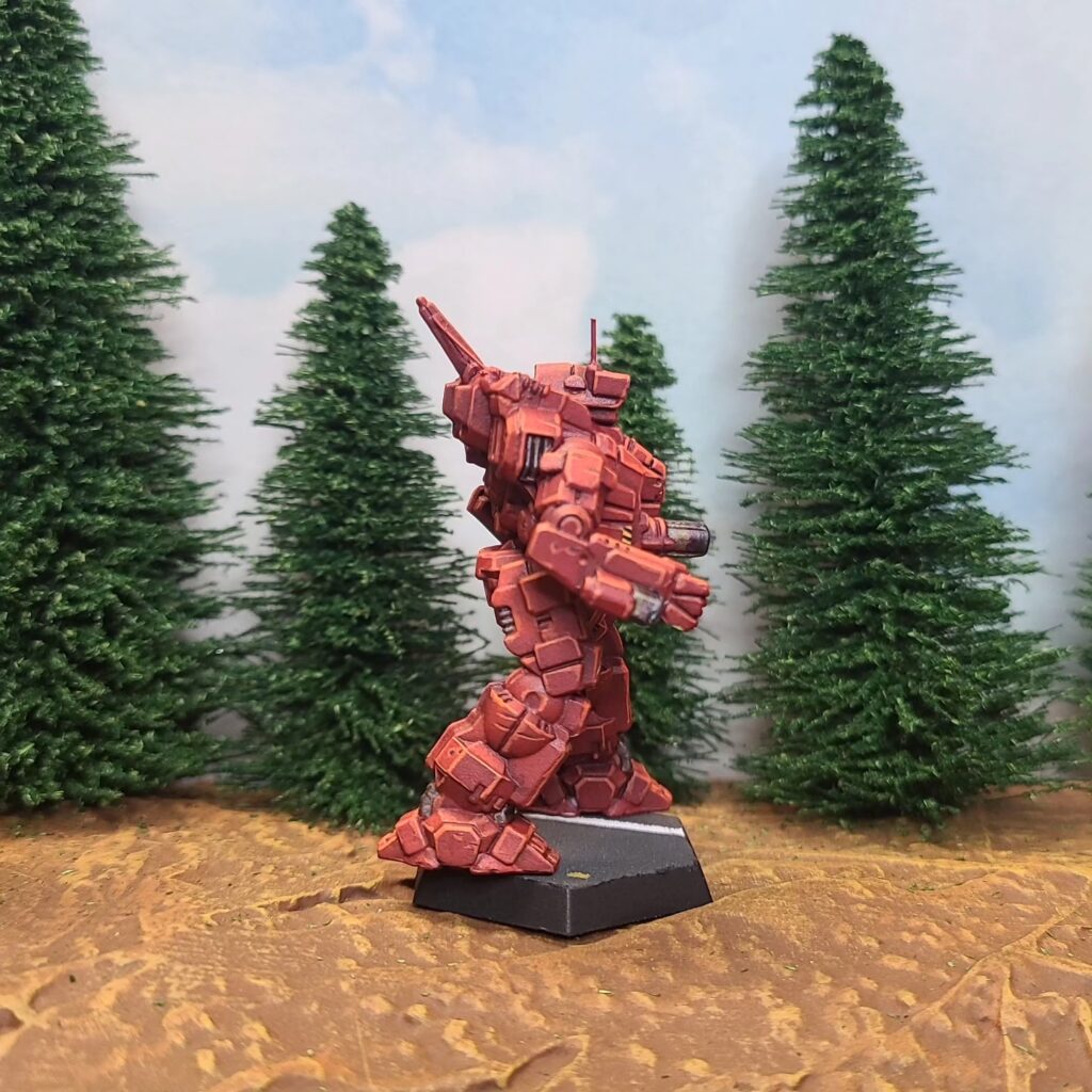 a Cyclops miniature painted red with a green cockpit