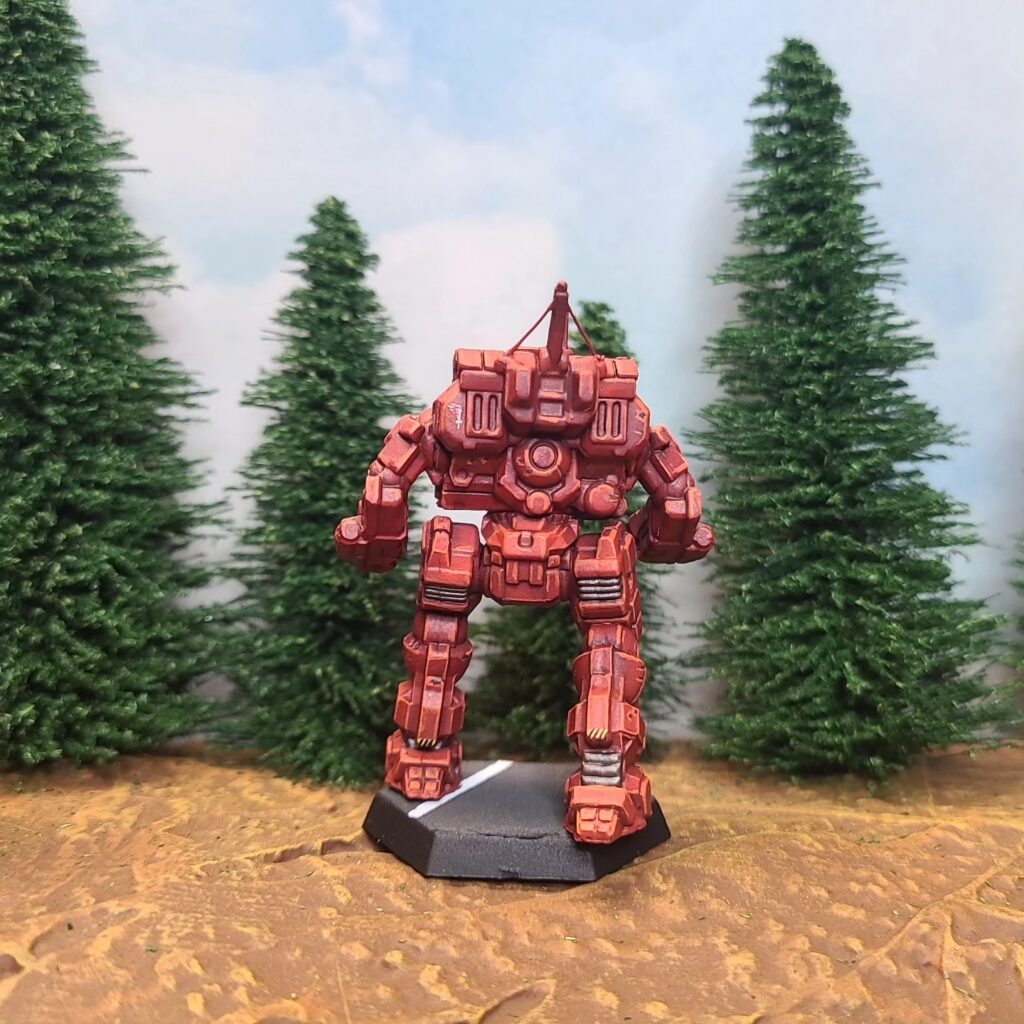 a Cyclops miniature painted red with a green cockpit