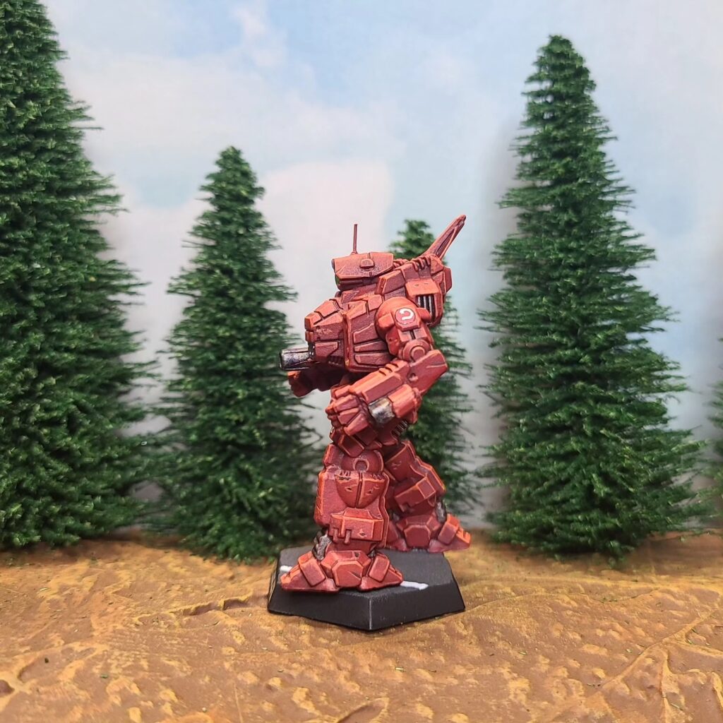 a Cyclops miniature painted red with a green cockpit