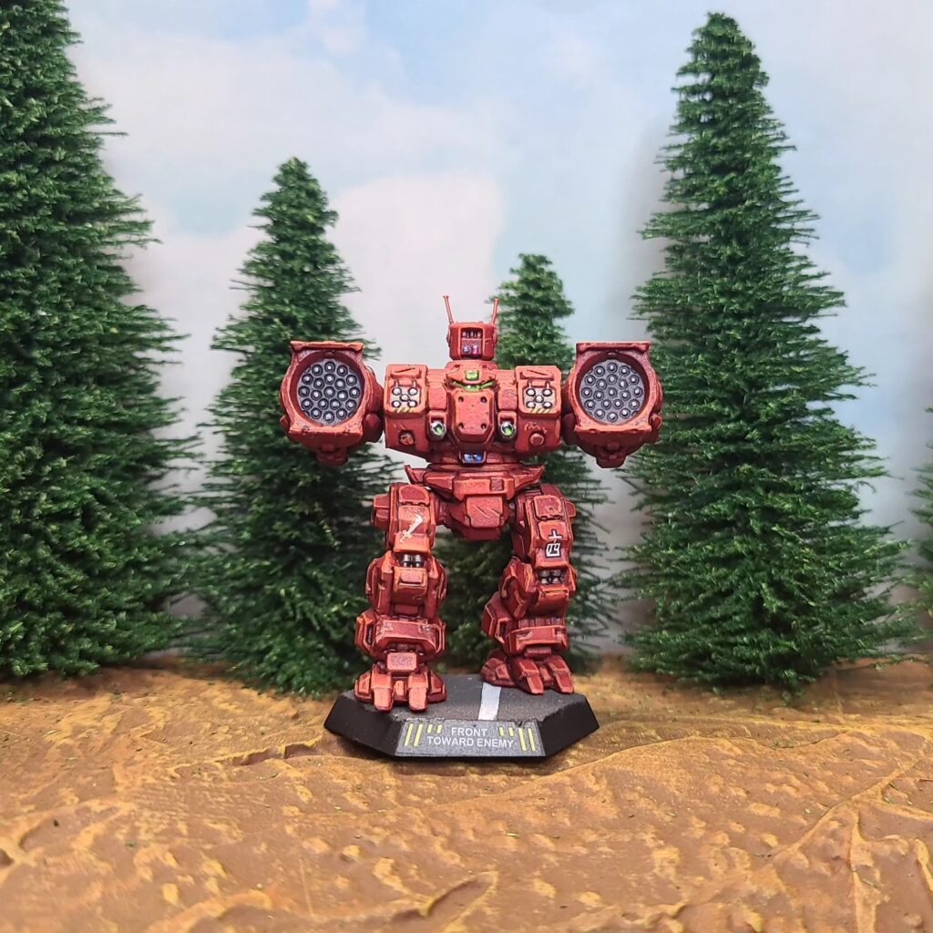 a Longbow miniature painted red with a green cockpit