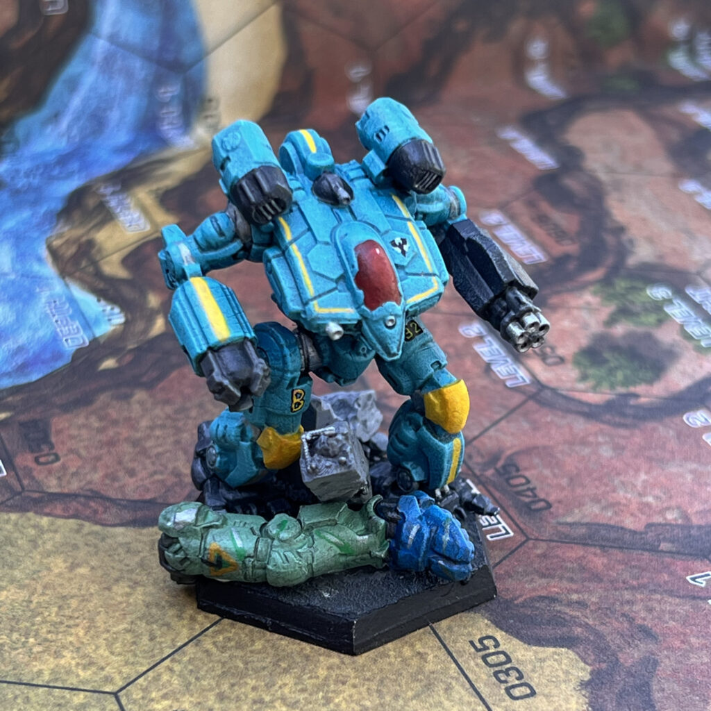 War Crow miniature painted in turquoise with yellow and grey accents