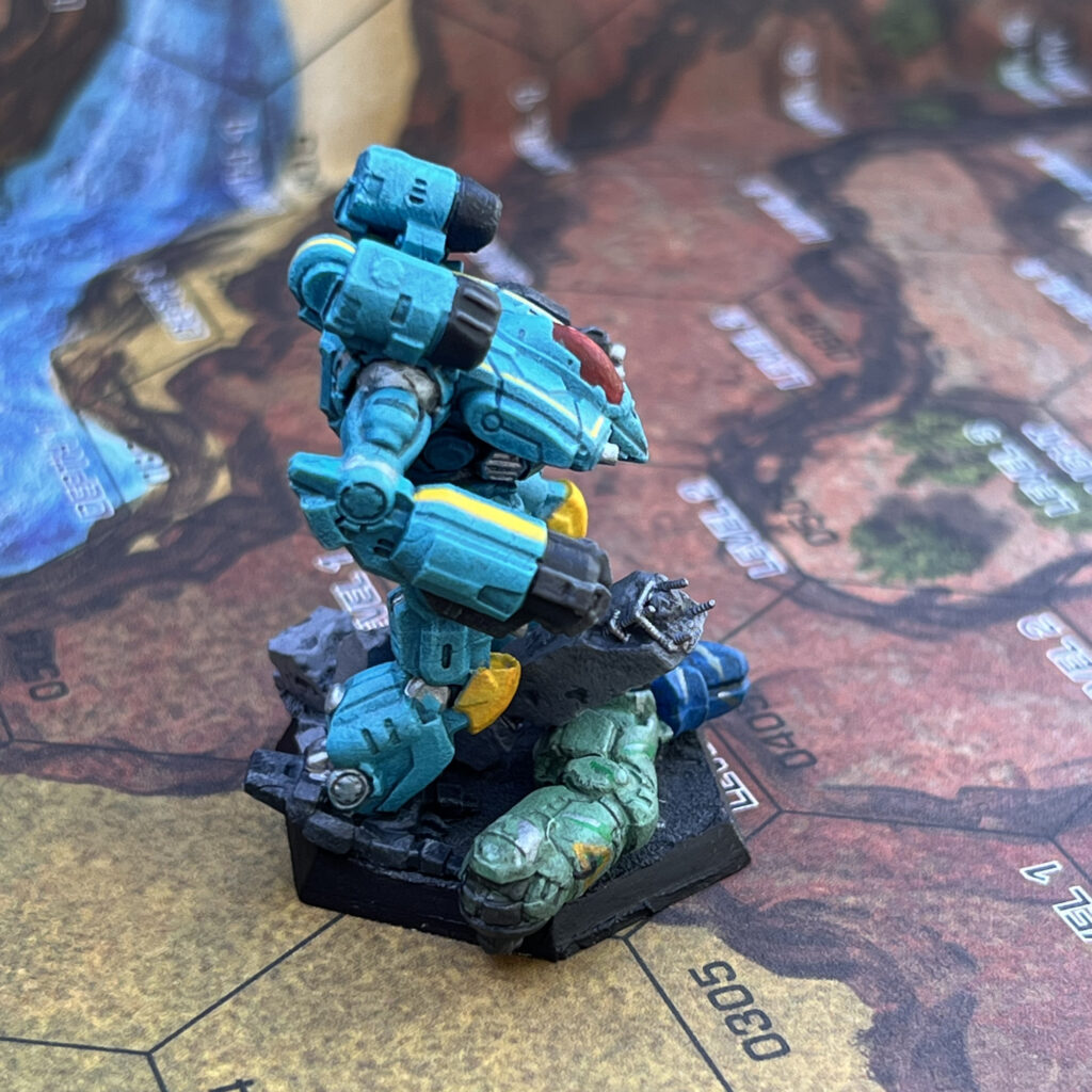 War Crow miniature painted in turquoise with yellow and grey accents