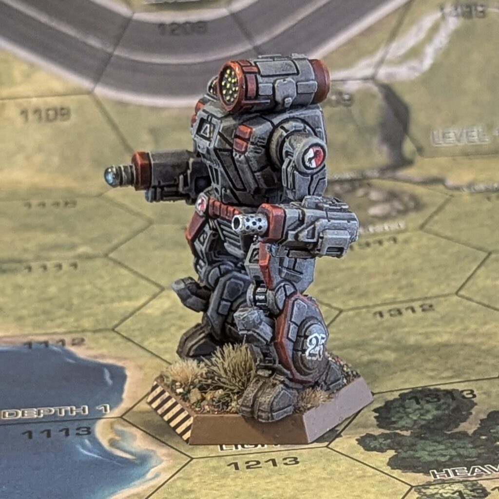 a Summoner miniature painted grey with red accents