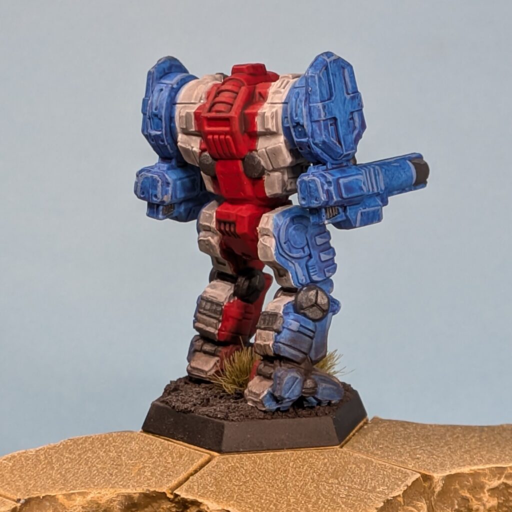 a Templar miniature painted in vertical stripes, blue to white to red in the center