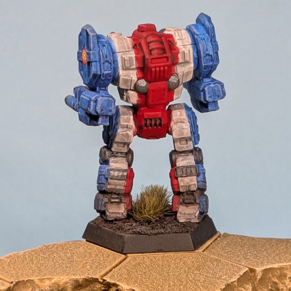 a Templar miniature painted in vertical stripes, blue to white to red in the center