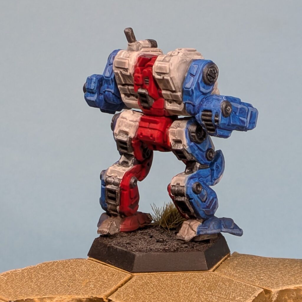 a Thanatos miniature painted in vertical stripes, blue to white to red in the center