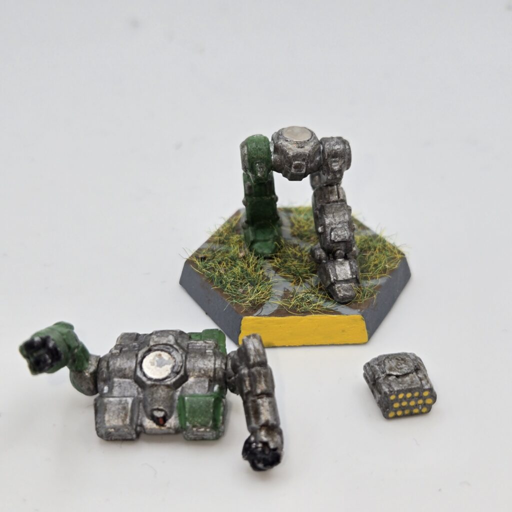 Howler miniature painted metallic grey with green accents. The torso has been magnetized and disassembled