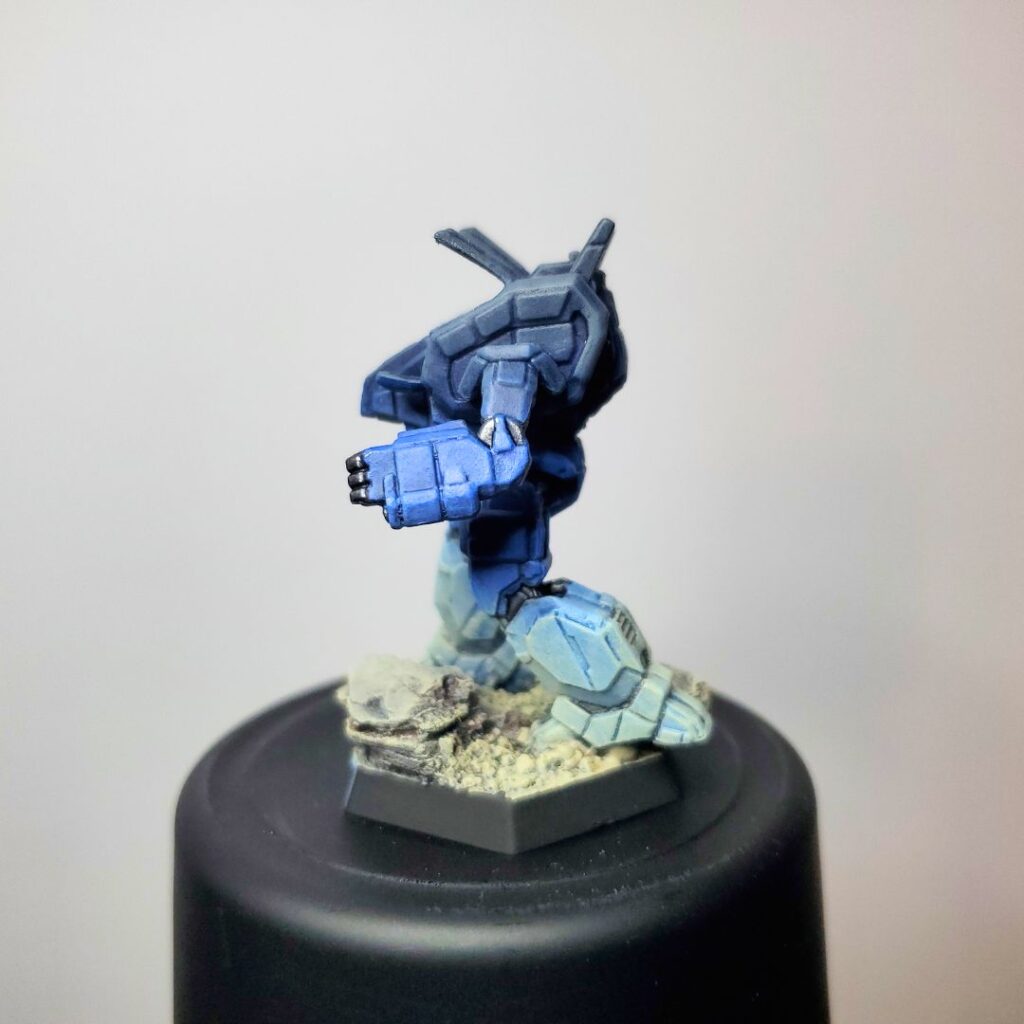 an Archer miniature painted in a grey-to-blue gradient