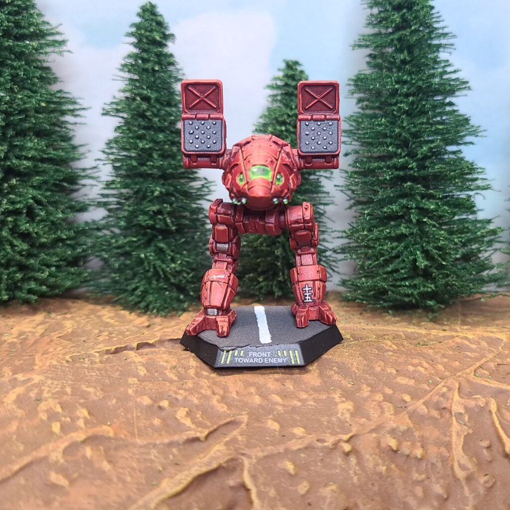 a Catapult miniature painted red with green cockpit accents