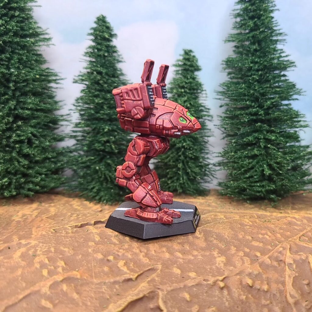 a Catapult miniature painted red with green cockpit accents