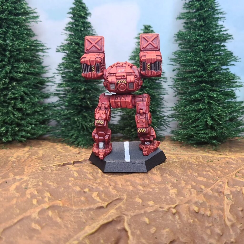 a Catapult miniature painted red with green cockpit accents
