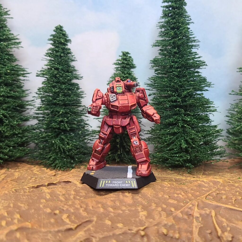 a Shadow Hawk miniature painted red with green cockpit accents