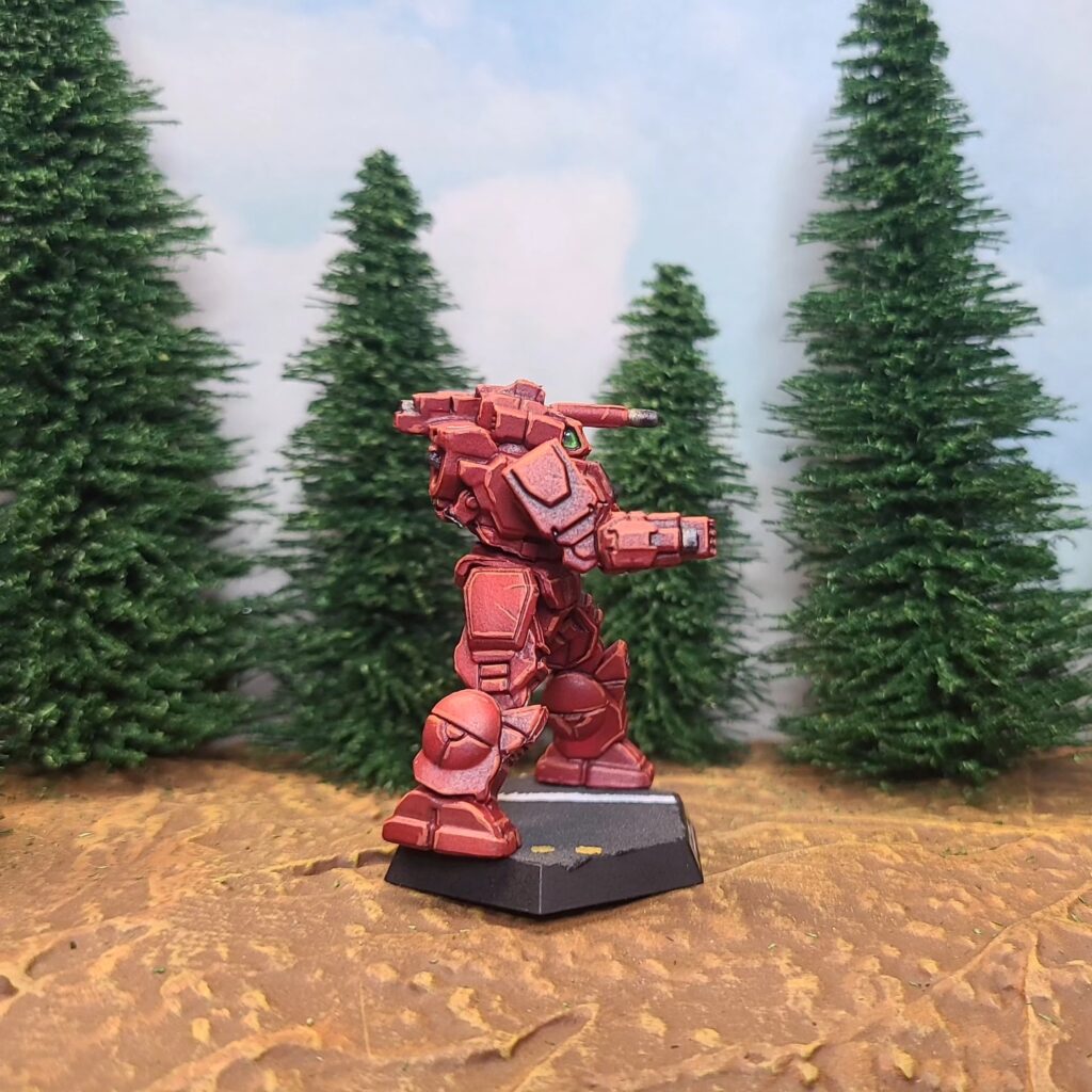 a Shadow Hawk miniature painted red with green cockpit accents