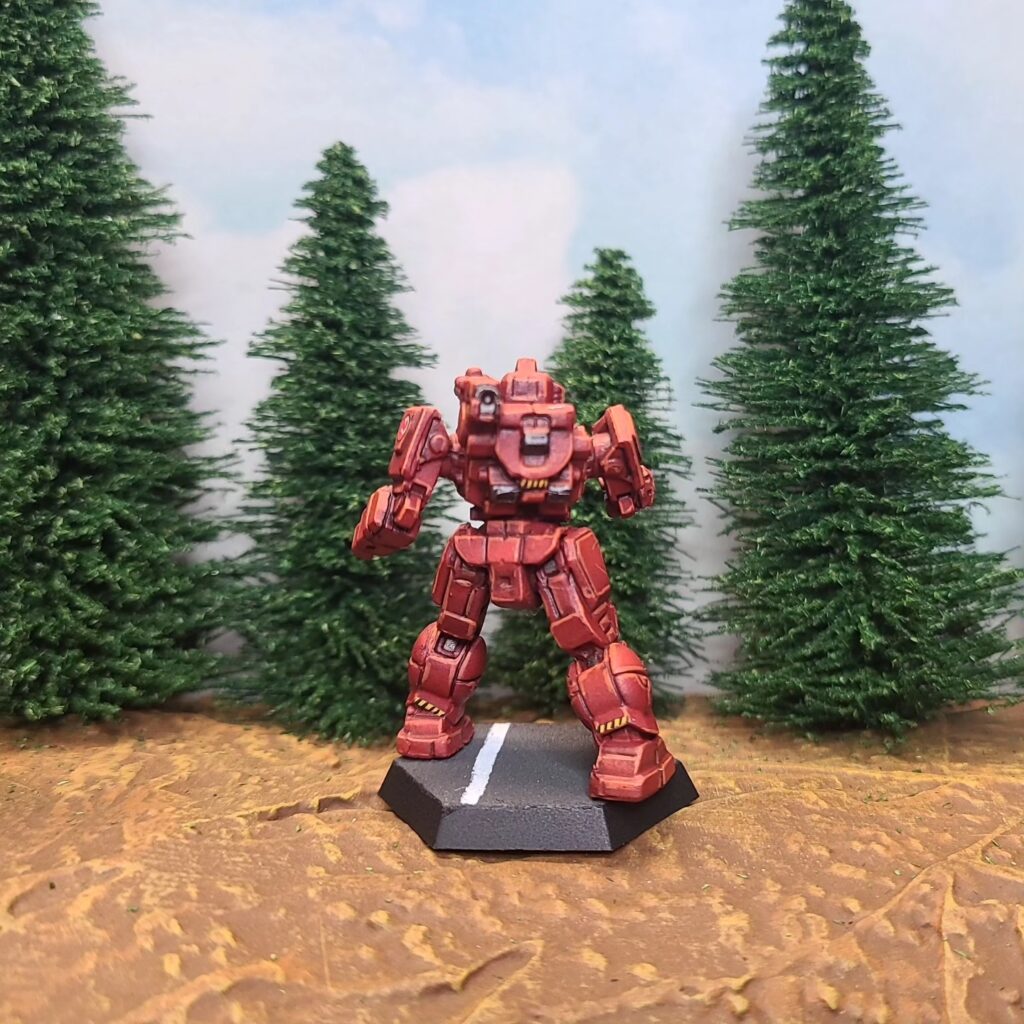 a Shadow Hawk miniature painted red with green cockpit accents