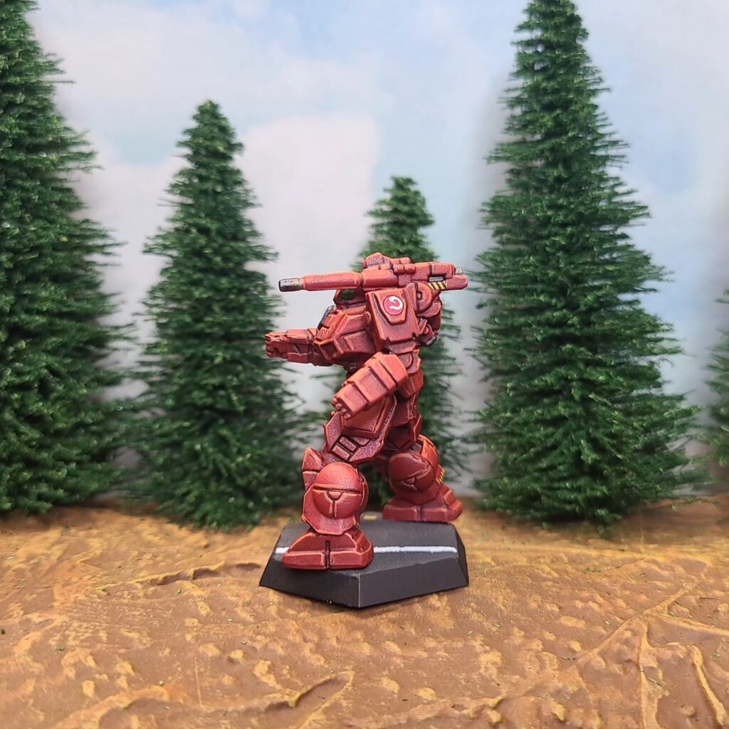 a Shadow Hawk miniature painted red with green cockpit accents