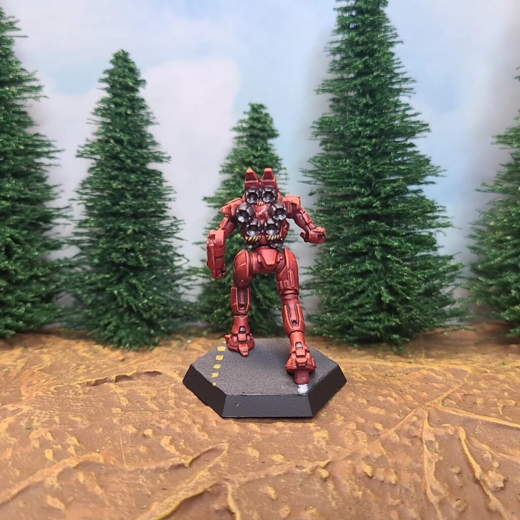 a Spider miniature painted red with green cockpit accents