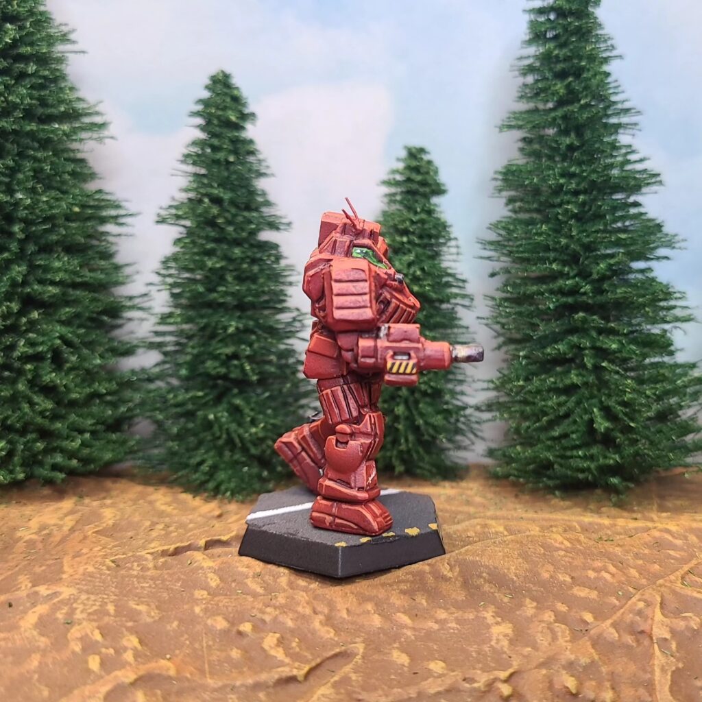 a Wolverine miniature painted red with green cockpit accents