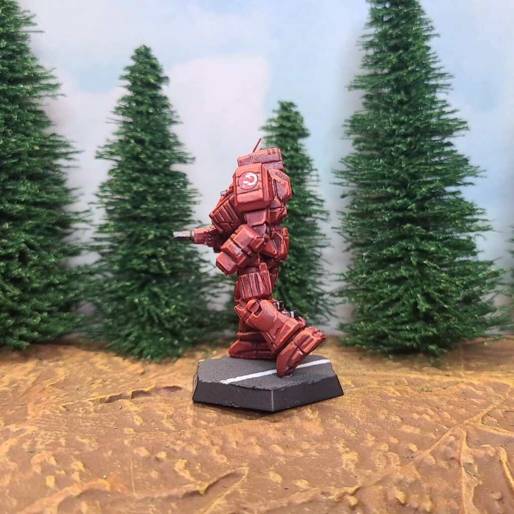 a Wolverine miniature painted red with green cockpit accents