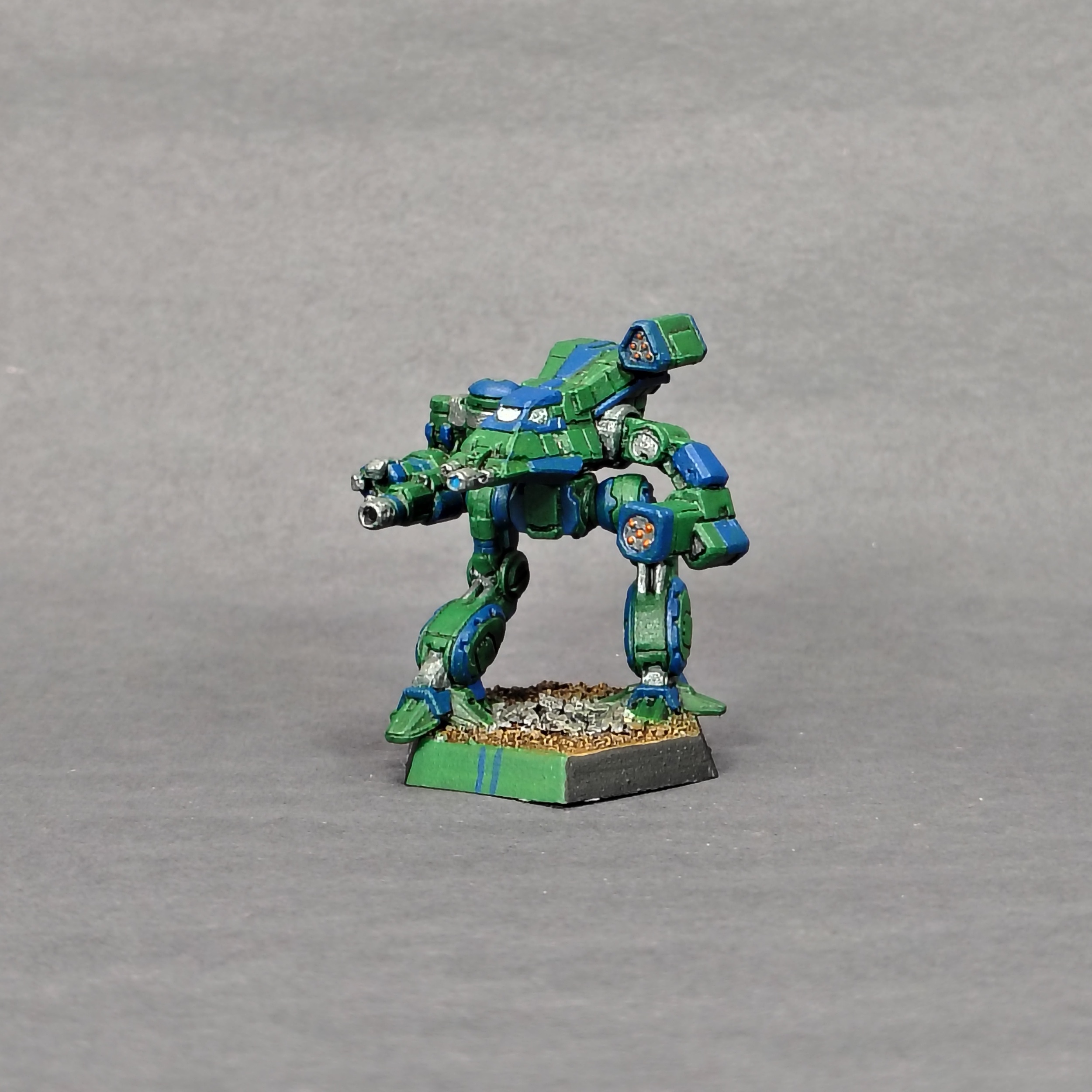 a Bushwacker miniature painted green with blue accents