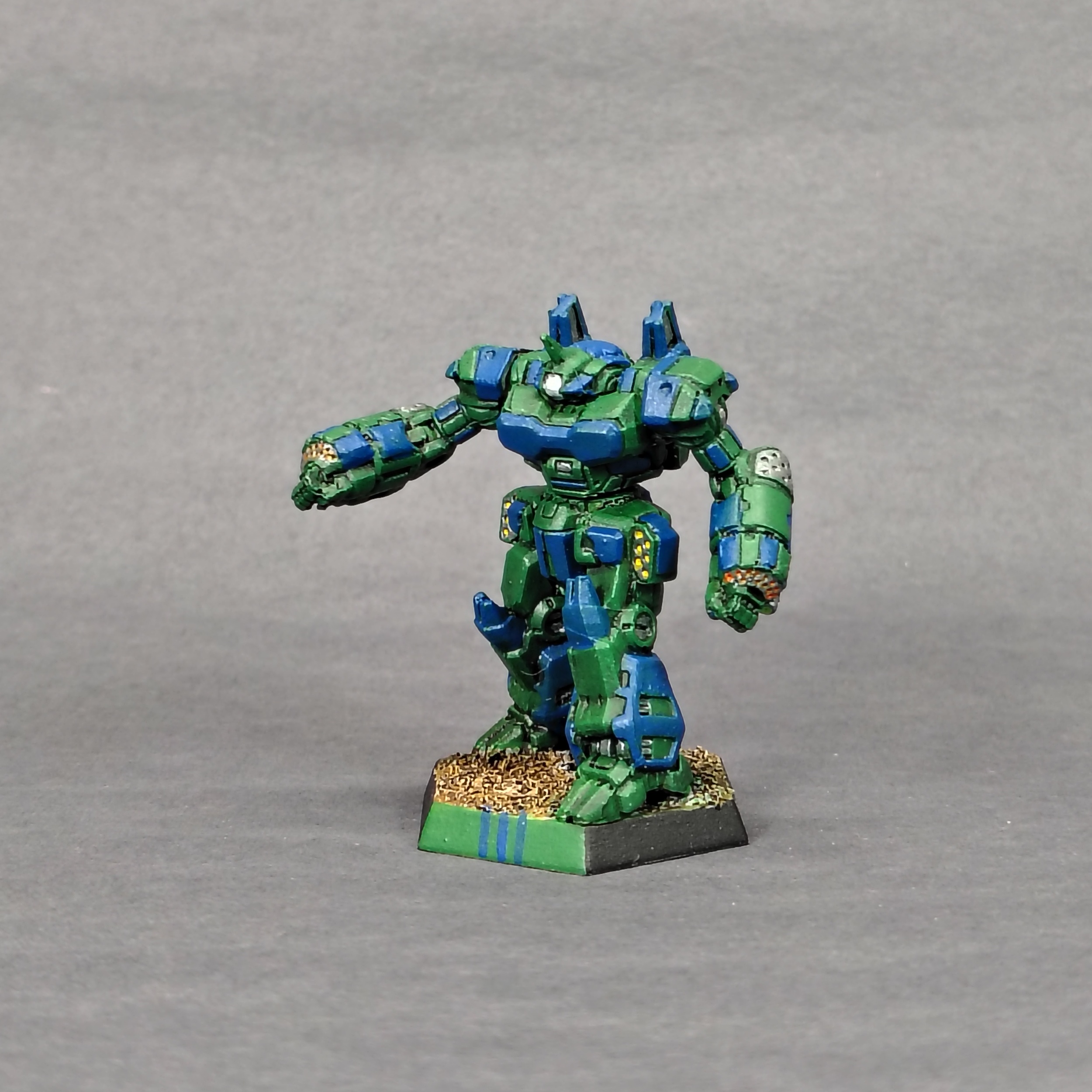 a Crusader miniature painted green with blue accents